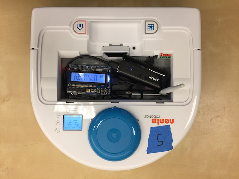 A picture of a Neato robotic vacuum cleaner with a custom remote control interface based on Raspberry Pi